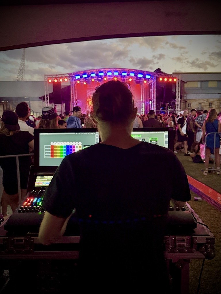 Fixture One at the lighting desk during a festival set